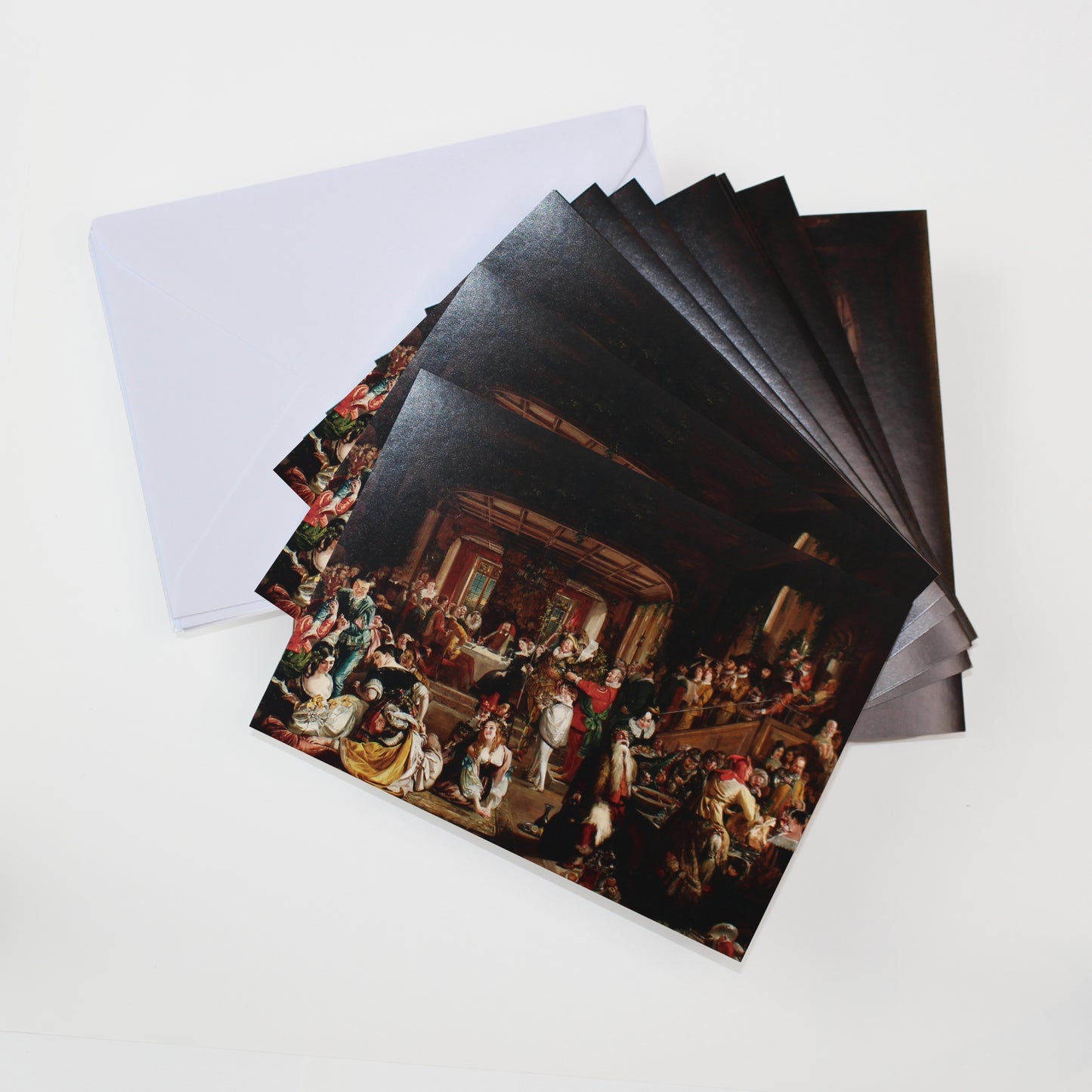 An open box showing 10 National Gallery of Ireland Christmas cards featuring Daniel Maclise's Merry Christmas in the Baron's Hall, and 10 envelopes.