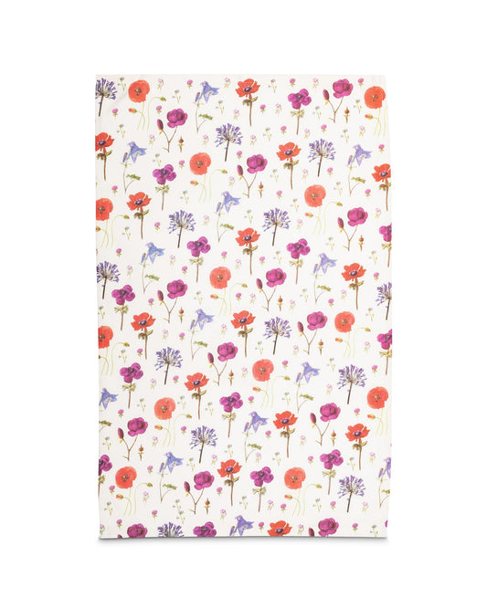 The rectangular tea towel laid out flat showing the repeating pattern of wildflowers.