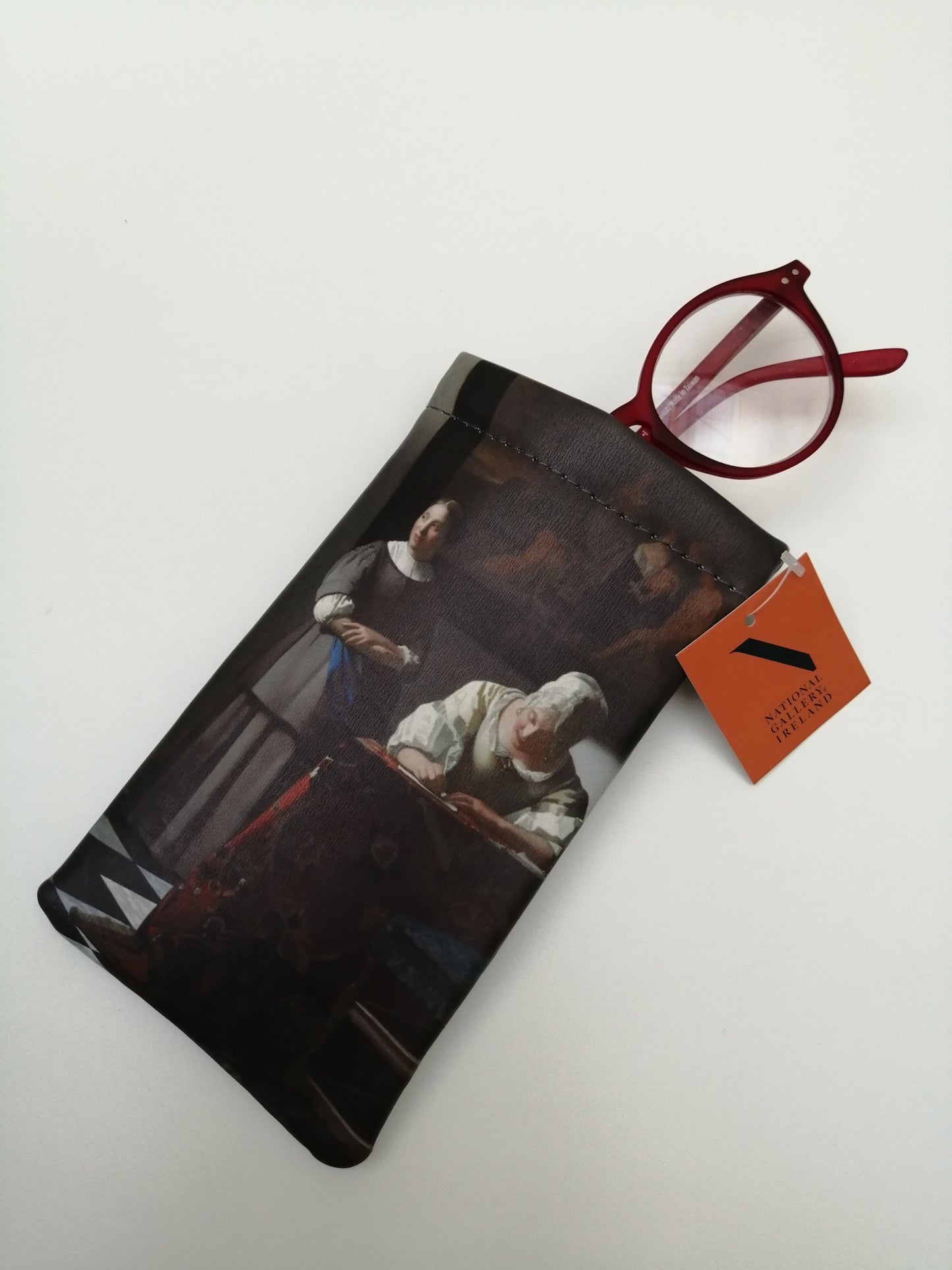 The previously described pouch but a pair of glasses are coming out of the top.
