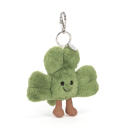 Plush keychain shaped like a shamrock with a smiling face on a white background