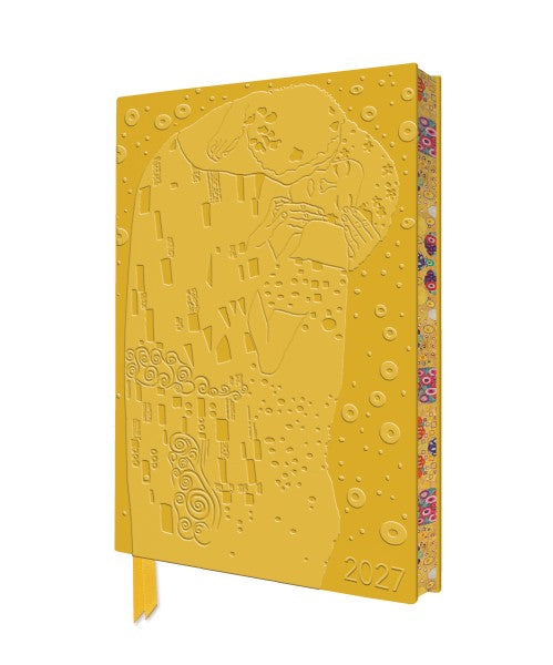 Yellow embossed notebook with artistic design on a white background