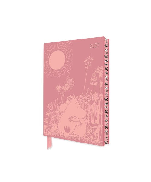 Pink notebook with nature-themed design on a white background