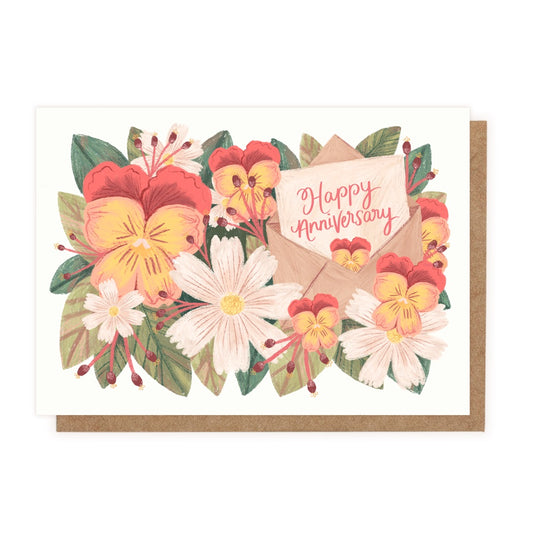 A drawing of pansies, daisies and green leaves with a small card that says Happy Anniversary in cursive.