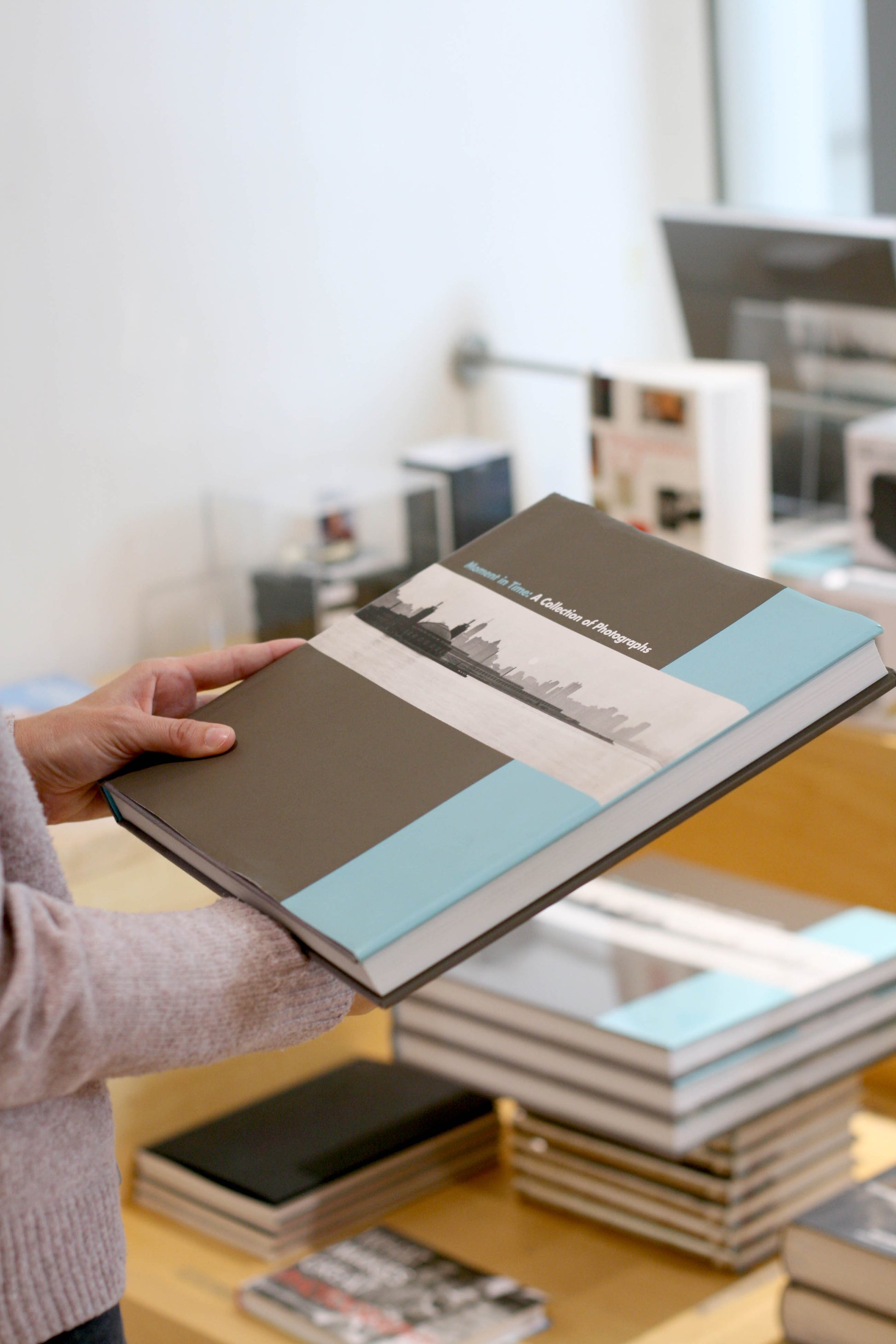 A photo of an unseen person holding the book.