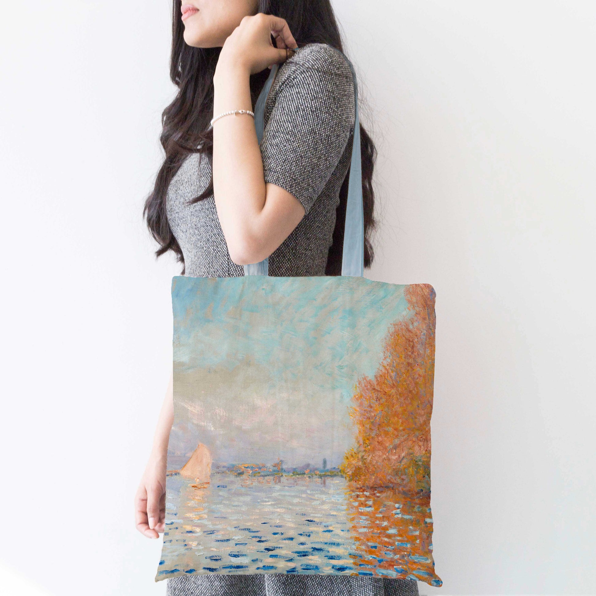 The previous bag being carried over the shoulder by a woman, showing the strap being roughly elbow length.